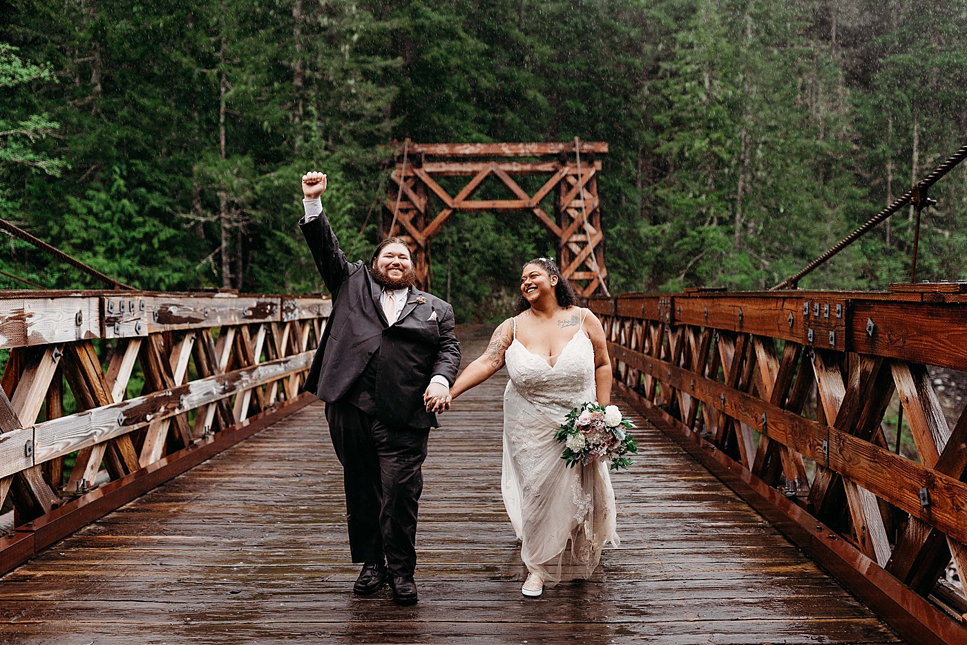 Bride and groom portraits in the rain at Mount Rainier elopement at Longmire | Photo by Megan Montalvo Photography