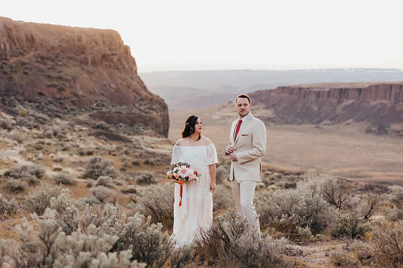 Bride and groom standing in desert at Vantage | Photo by Megan Montalvo Photography