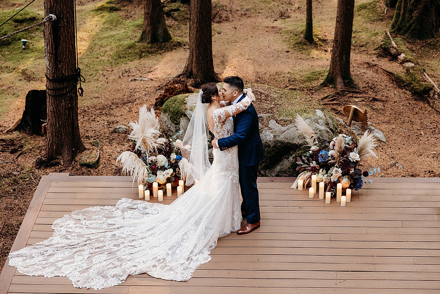 Bride and groom first kiss at Emerald Forest Treehouse | Photo by Megan Montalvo Photography