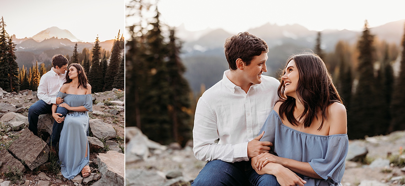 Couple sitting on rocks, looking at each other during photoshoot at Tipsoo Lake | Photo by Megan Montalvo Photography