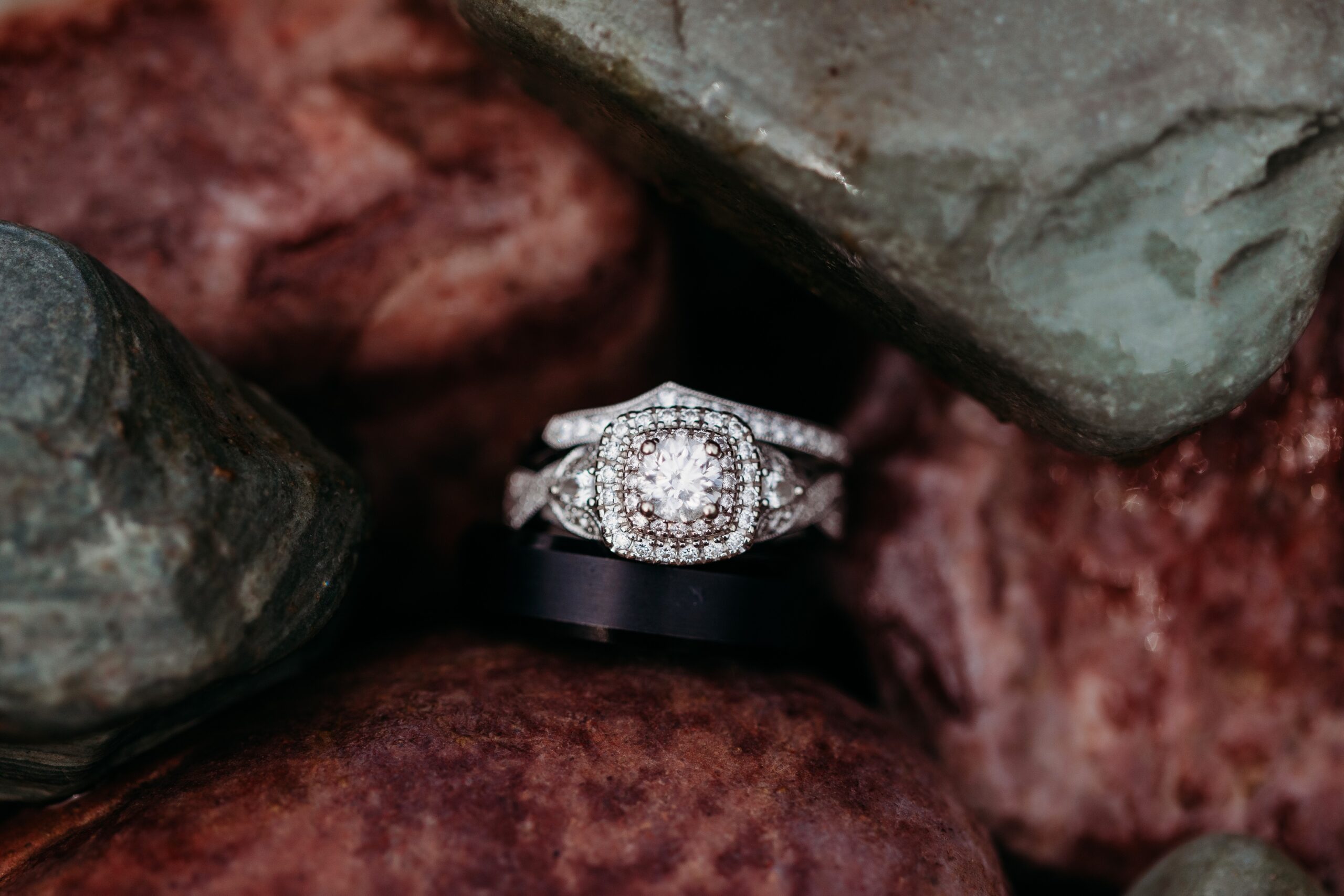 diamond rings stacked together amongst rocks