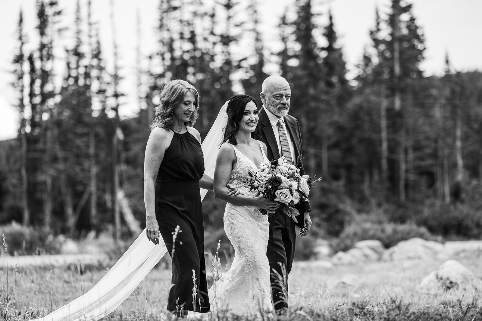 bride walks down aisle in woods during elopement