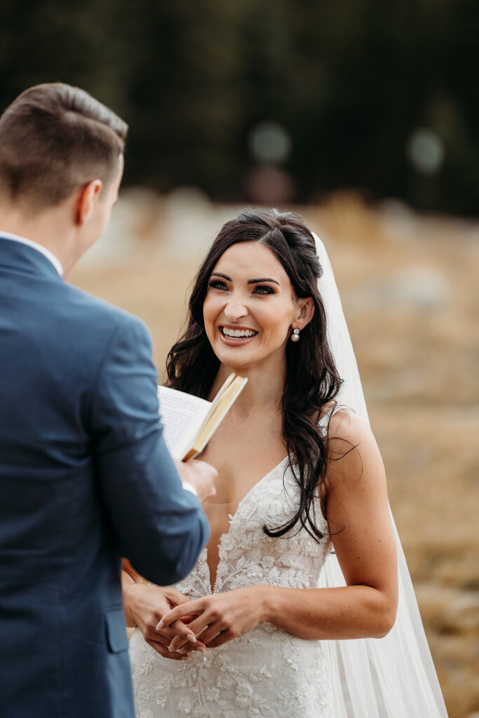 bride smiles at groom during ceremony elopement