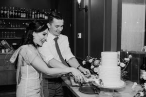 bride and groom cut the cake together