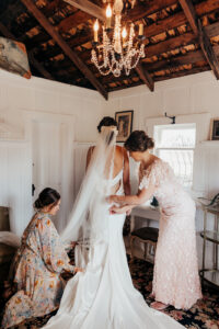 bride is pampered by mom and sister