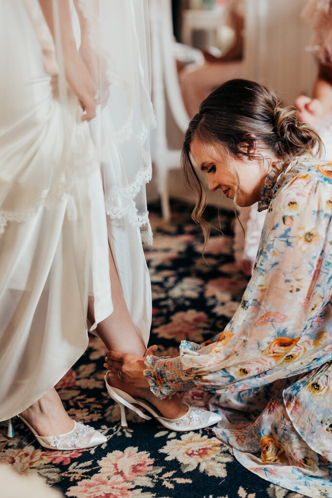 woman puts bride shoes on