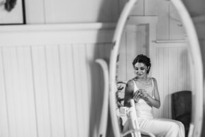 bride is reflected in antique mirror
