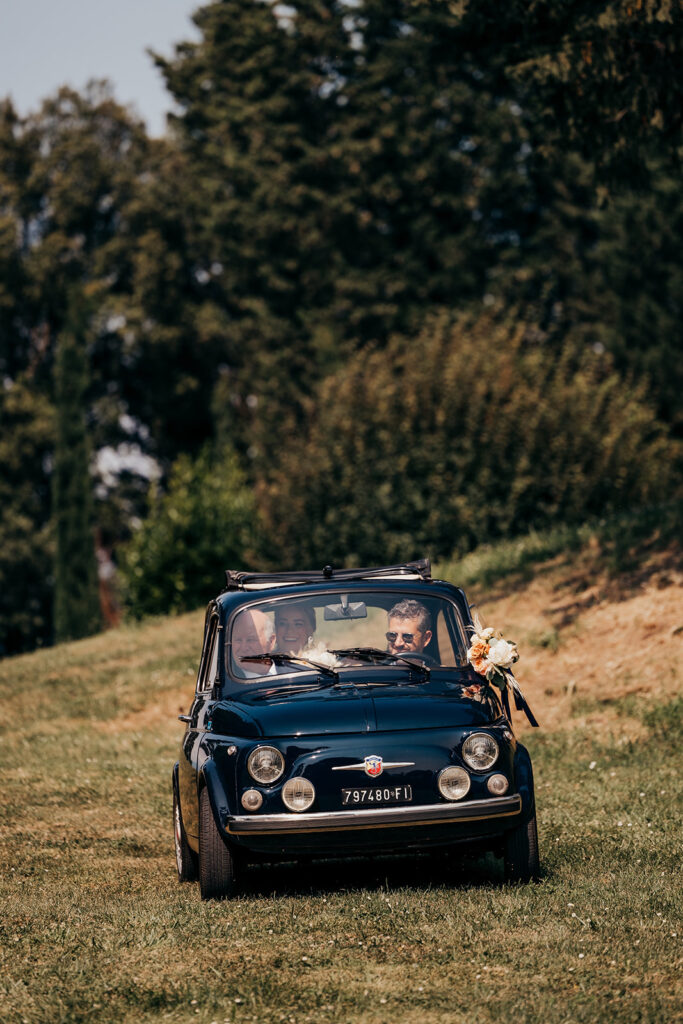 vintage car driving in grass