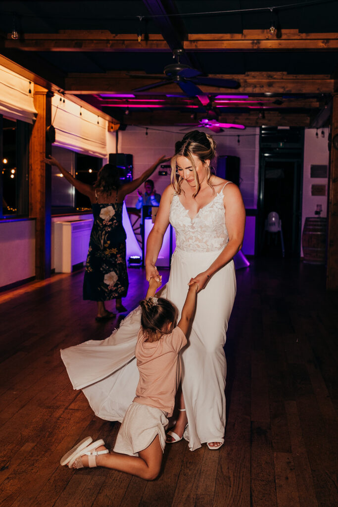 bride dances with little girl