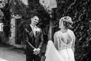 groom looks fondly at bride during first look
