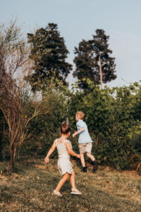 little kids running through field