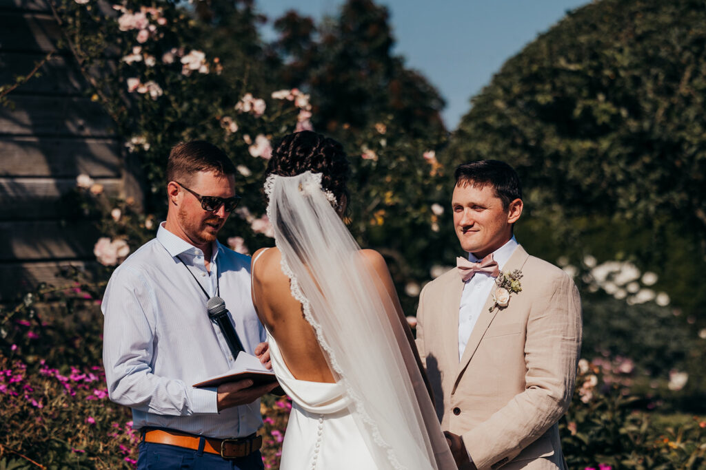 groom looks at bride during wedding ceremony
