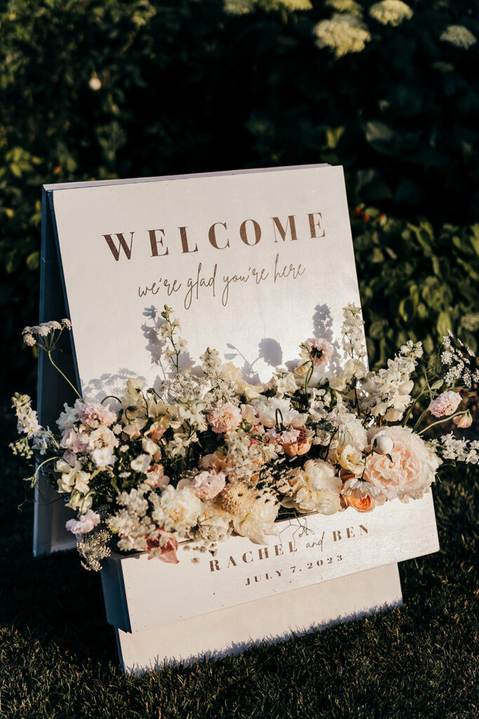 welcome sign at wedding with florals