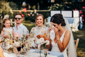 bride wipes tears away during toasts
