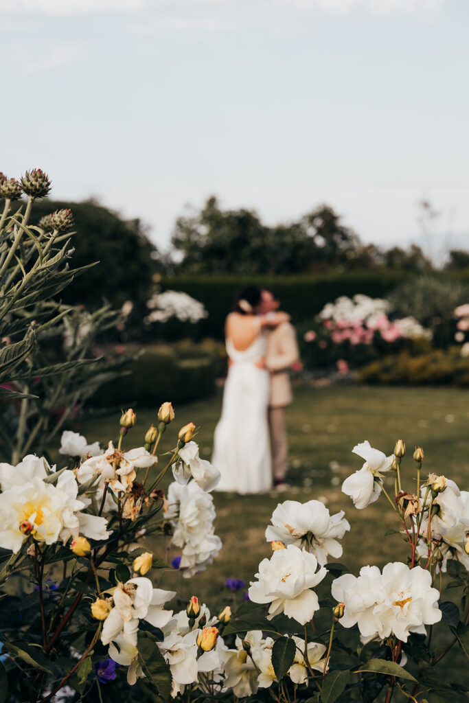 bride and groom share first dance in a garden