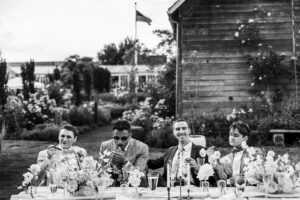 wedding guests sit together at reception table