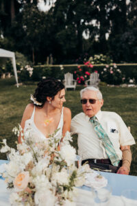 bride sits with olderman