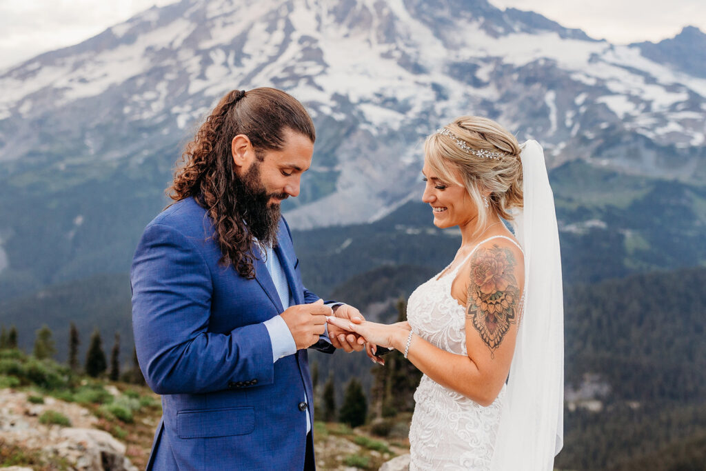 bride and groom exchange rings on mt rainier