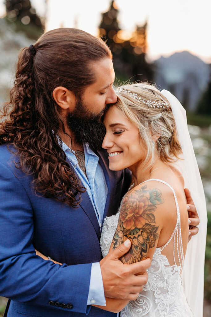 bride and groom embrace on mt rainier