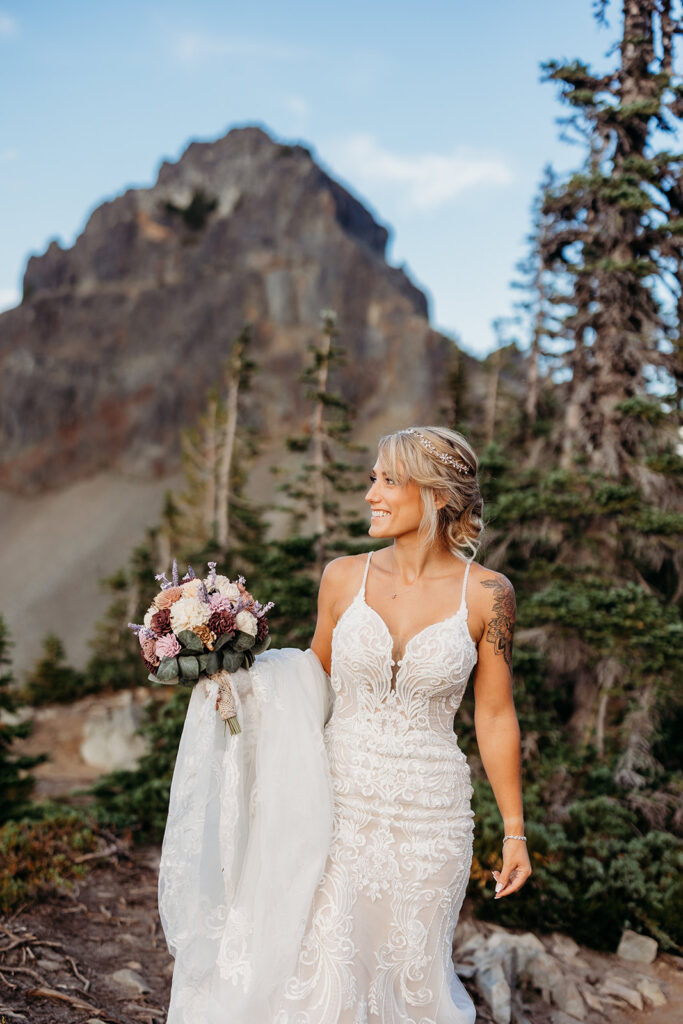 bride poses in classic wedding dress on mt rainier